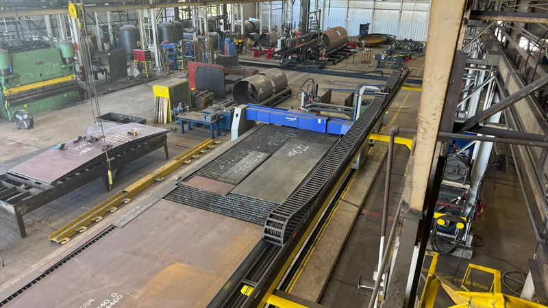 Overhead view of the Ramco shop floor with the CNC burn table, press brake, and tank shells